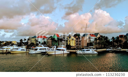 Luxury Yachts at Tropical Marina at Sunrise with Colorful Buildings Luxury Yachts at Tropical Marina at Sunrise with Colorful Buildings 113230230