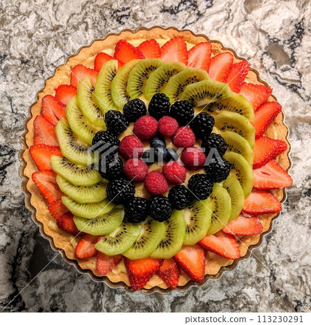 Colorful Fruit Tart with Fresh Berries on Marble - Top View 113230291