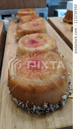 Artisanal Pineapple Cakes with Coconut on Wooden Surface Artisanal Pineapple Cakes with Coconut on Wooden Surface 113230360