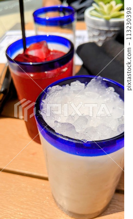 Refreshing Summer Drinks on Wooden Table, Eye-Level View 113230398
