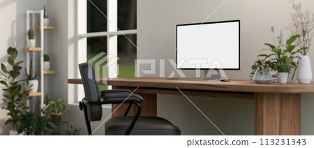A computer mockup on a rustic wood computer desk in a minimalist home office with houseplants. 113231343