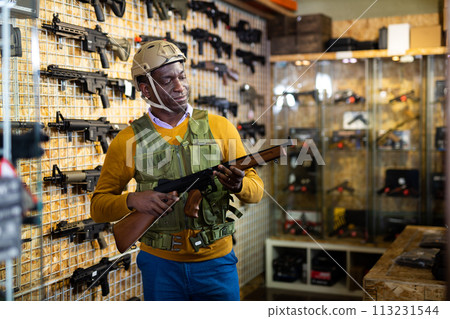 African-american man in weapon shop African-american man in weapon shop 113231544