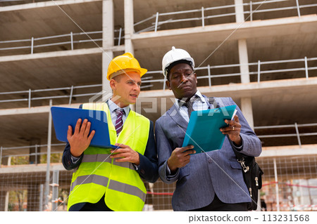 Architect and engineer talking about project of new building Architect and engineer talking about project of new building 113231568