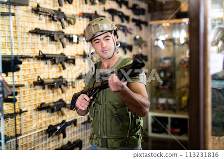 Man in army uniform with weapon in military market Man in army uniform with weapon in military market 113231816