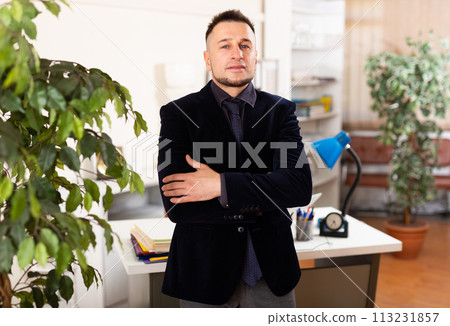 Confident young man working at office Confident young man working at office 113231857