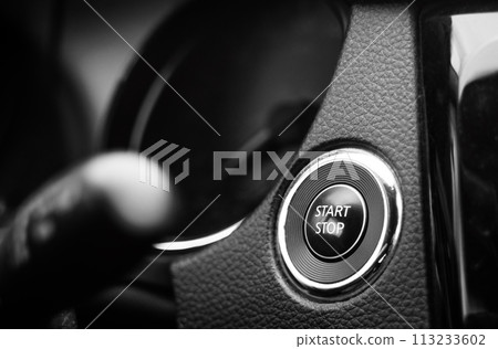 Engine start and stop button on dashboard. Keyless smart key on a modern vehicle. 113233602