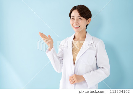 Woman in white coat holding hands 113234162