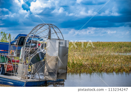 airboat in the everglades of Florida with grass and wetland swamp in the background airboat in the everglades of Florida with grass and wetland swamp in the background 113234247