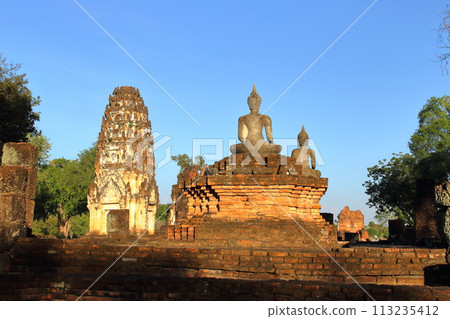 Pagodas and Buddhist statues at Wat Phra Pa Iluang ruins in Sukhothai Historical Park, a world cultural heritage site in Sukhothai, the ancient capital of northern Thailand 113235412