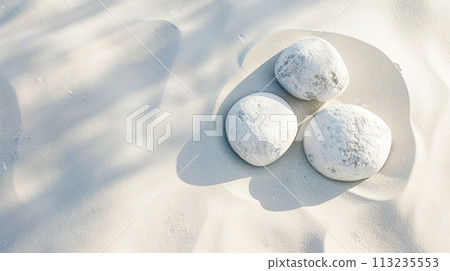 Beautiful white sand and three white round stones background 113235553