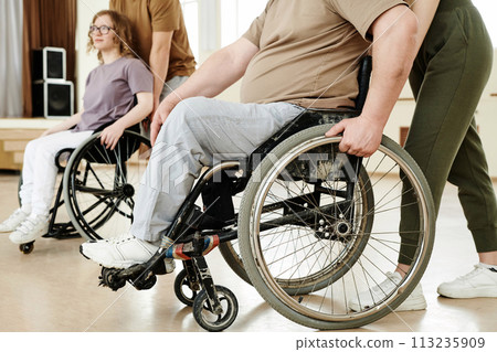 Crop shot of two people with disabilities and their partners practicing dance with wheelchairs in studio 113235909
