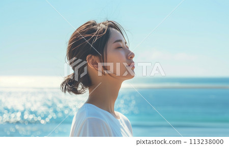 A woman standing by the sea A woman standing by the sea 113238000