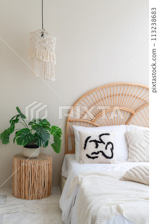 White pillows on wooden weave bed in minimal bedroom interior with green plants. Real photo White pillows on wooden weave bed in minimal bedroom interior with green plants. Real photo 113238683