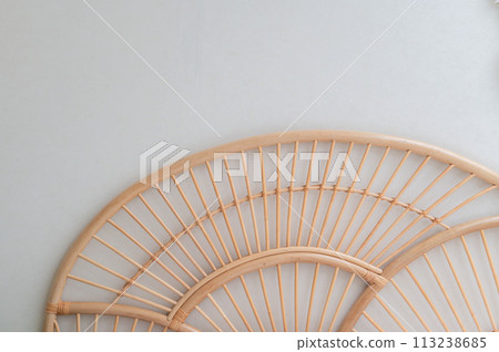 Detail image of a bedroom with woven brown wooden headboard with white wall. real photo 113238685
