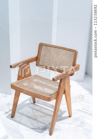 Weave chair handmade or rattan woven chair in white room on summer day. real photo Weave chair handmade or rattan woven chair in white room on summer day. real photo 113238692
