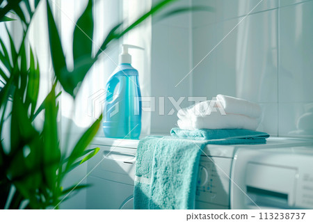 Stack of clean towels on modern washing machine with blurred background. The towels showcasing their soft and fluffy 113238737