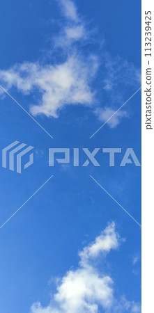 Beautiful view over the blue sky with white clouds 113239425