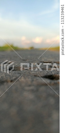 Rural roads are full of grass and quiet in the afternoon 113239461