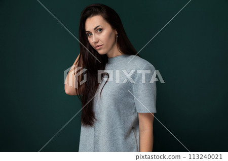 Woman Standing in Front of Green Wall Woman Standing in Front of Green Wall 113240021