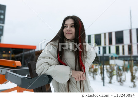 Woman With Long Hair Standing in the Snow 113240084