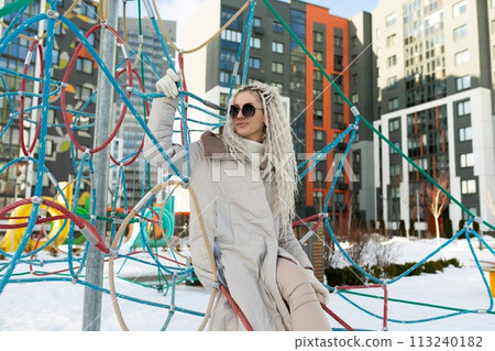 Woman With Long White Hair and Sunglasses at Playground Woman With Long White Hair and Sunglasses at Playground 113240182