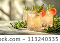 A light cocktail in a glass on the table. 113240335