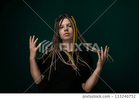 Woman With Dreadlocks in Front of Green Background 113240752