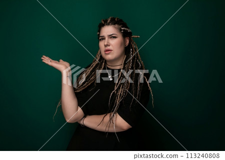 Woman With Dreadlocks in Front of Green Background 113240808