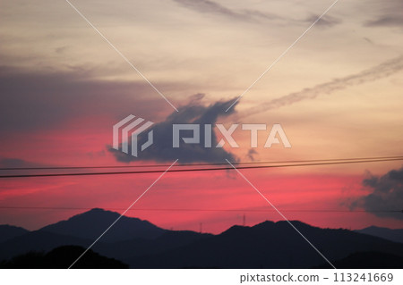 The dark red western sky and clouds at dusk 113241669