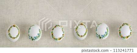 Easter eggs on a linen tablecloth Holiday background Composition with Easter eggs on embroidery on an eggshell Easter holiday background for text billboard banner postcard calendar background for text 113241771