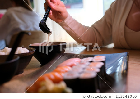 Miso soup is a traditional Japanese soup made primarily of miso paste, dashi broth, and additional ingredients such as vegetables, seaweed, and tofu 113242010