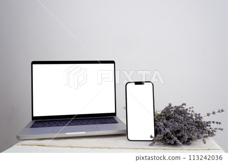 using mobile smart phone, black screen phone, sms, video calls, office desk resume info and blank screen on tablet, purple lavender flower find work concept. View office desk. 113242036