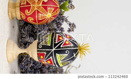 krashanka cross banner space for advertising Homemade hand painted easter eggs on wooden stands on lavender background dried flowers easter krashanka cross banner space for advertising Homemade hand painted easter eggs on wooden stands on lavender background dried flowers easter 113242468
