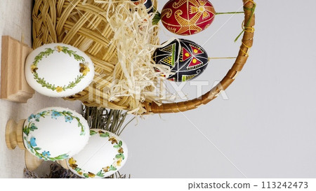 easter composition with phone with white chroma key screen for advertising basket of eggs with embroidery eggs painted lavender flowers wooden coasters on a white background Easter holiday easter composition with phone with white chroma key screen for advertising basket of eggs with embroidery eggs painted lavender flowers wooden coasters on a white background Easter holiday 113242473