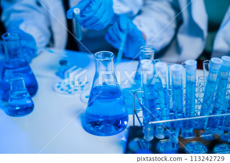 biotechnologist testing new chemical substances in a laboratory. 113242729