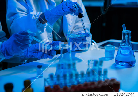biotechnologist testing new chemical substances in a laboratory. 113242744