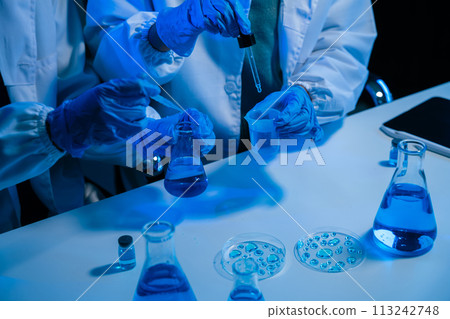 biotechnologist testing new chemical substances in a laboratory. 113242748