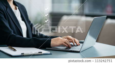 Businesswoman using tablet to do online checklist survey, doing assessment online survey answer test questions Digital form. 113242751