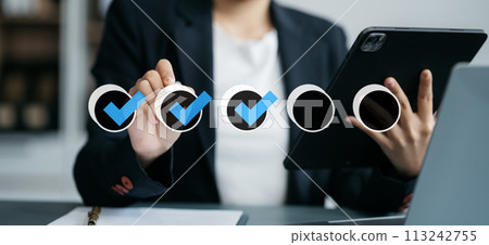 Business performance checklist concept, businessman using tablet and laptop doing online checklist survey, filling out digital form checklist. 113242755