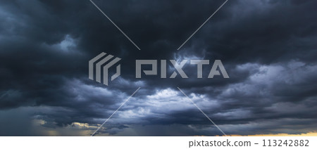 The dark sky with heavy clouds converging and a violent storm before the rain.Bad or moody weather sky and environment. carbon dioxide emissions, greenhouse effect, global warming, climate change. 113242882