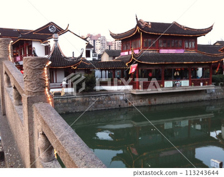 Old buildings beside a canal in Shanghai seen from the bridge Old buildings beside a canal in Shanghai seen from the bridge 113243644
