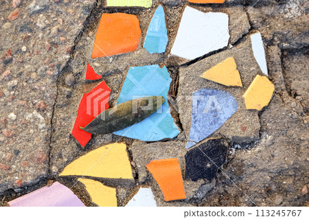 Flooring with broken tiles in pavement pattern with old leaf, fixing broken roads Flooring with broken tiles in pavement pattern with old leaf, fixing broken roads 113245767