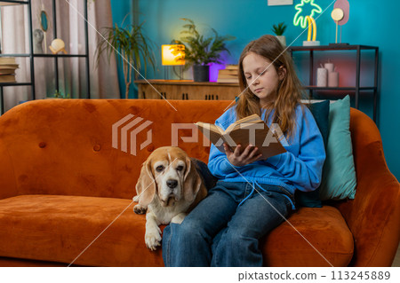 Happy preteen girl reading book turning pages smiling enjoying literature education 113245889