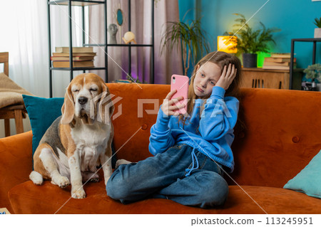 Upset child kid girl using smartphone playing game loses bad news fail education study test at home Upset child kid girl using smartphone playing game loses bad news fail education study test at home 113245951