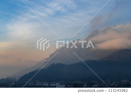Beautiful landscape of the layered misty hazy Italian Alps mountain range during evening. Lombardy, Italy Beautiful landscape of the layered misty hazy Italian Alps mountain range during evening. Lombardy, Italy 113245962
