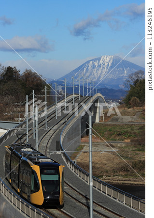 Utsunomiya Light Rail HU300 series train heading towards Utsunomiya city with the spectacular view of Mt. Nantai in the background_Photo taken on March 2, 2024 Utsunomiya Light Rail HU300 series train heading towards Utsunomiya city with the spectacular view of Mt. Nantai in the background_Photo taken on March 2, 2024 113246195