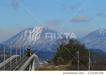 Utsunomiya Light Rail HU300 series train heading towards Utsunomiya city with the spectacular view of Mt. Nantai in the background_Photo taken on March 2, 2024 Utsunomiya Light Rail HU300 series train heading towards Utsunomiya city with the spectacular view of Mt. Nantai in the background_Photo taken on March 2, 2024 113246198