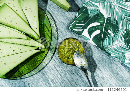 slices of pesto cheese and pesto sauce 113246201