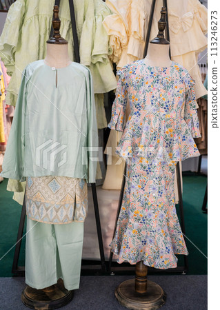 View of the children baju melaju and mini kurung set selling in the shopping mall. View of the children baju melaju and mini kurung set selling in the shopping mall. 113246273