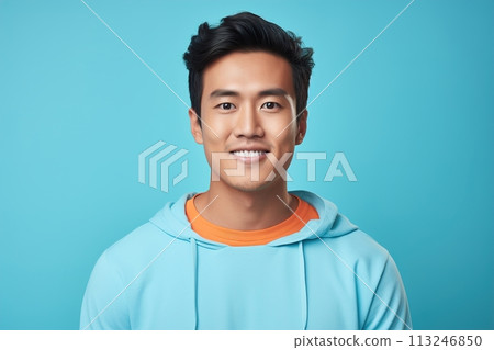 A man with a blue hoodie and orange shirt is smiling 113246850